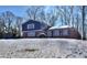 Two-story house with blue siding, brick base, and snowy yard at 4593 Bexley Way, Stone Mountain, GA 30083