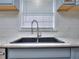 Modern kitchen sink with a gooseneck faucet and hexagon tile backsplash at 4593 Bexley Way, Stone Mountain, GA 30083