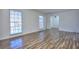 Spacious living room with wood-look floors and large windows at 4593 Bexley Way, Stone Mountain, GA 30083