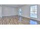 Spacious living room with wood-look floors and large windows at 4593 Bexley Way, Stone Mountain, GA 30083