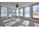 Sunroom with wood-look floors, multiple windows, and ceiling fan at 4593 Bexley Way, Stone Mountain, GA 30083