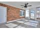 Sunroom with brick wall, wood-look floors, and ceiling fan at 4593 Bexley Way, Stone Mountain, GA 30083