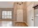 Bright entryway with hardwood floors, chandelier, and white door at 6 Westchester Sq, Decatur, GA 30030