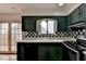 Kitchen with green cabinets and checkered backsplash at 6 Westchester Sq, Decatur, GA 30030