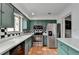 Kitchen with stainless steel appliances and green cabinets at 6 Westchester Sq, Decatur, GA 30030