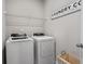 Convenient laundry room with washer, dryer, and shelving at 1182 Chastain Dr # 8, Sugar Hill, GA 30518