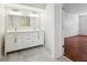 Bathroom featuring double sinks, quartz countertops, and gray flooring at 134 Shadow Lake Sw Dr, Lilburn, GA 30047