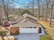 Aerial view of a home with brick siding, a two-car garage, and a spacious back deck at 3660 Hickory Se Cir, Smyrna, GA 30080