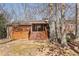 Backyard view of a house with a wooden deck, stairs, and mature trees at 3660 Hickory Se Cir, Smyrna, GA 30080