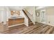 Spacious basement area with a staircase, kitchenette, wood flooring, and bathroom access at 3660 Hickory Se Cir, Smyrna, GA 30080
