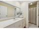 Well-lit bathroom featuring a white vanity and a view of the shower at 3660 Hickory Se Cir, Smyrna, GA 30080