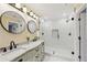 Bright bathroom with double sinks, granite counters, and a glass-enclosed shower at 3660 Hickory Se Cir, Smyrna, GA 30080