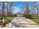 Long concrete driveway leading to a two-car garage, surrounded by landscaped yard at 3660 Hickory Se Cir, Smyrna, GA 30080