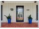 Close-up of the front door with decorative plants and a patterned tile porch at 3660 Hickory Se Cir, Smyrna, GA 30080