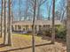 Well-maintained brick ranch with black shutters and a cozy front porch, surrounded by mature trees at 3660 Hickory Se Cir, Smyrna, GA 30080