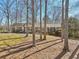 Traditional brick home with a charming front porch framed by mature trees in a natural setting at 3660 Hickory Se Cir, Smyrna, GA 30080