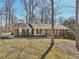Charming brick ranch home with a columned front porch, mature trees, and an inviting landscape at 3660 Hickory Se Cir, Smyrna, GA 30080