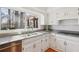 Bright kitchen featuring granite countertops, white subway tile backsplash, and a view to the backyard at 3660 Hickory Se Cir, Smyrna, GA 30080