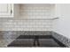Close-up of the kitchen cooktop featuring granite countertops and a white subway tile backsplash at 3660 Hickory Se Cir, Smyrna, GA 30080