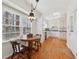 Eat-in kitchen featuring hardwood floors, white cabinets, and a breakfast nook with beautiful natural light at 3660 Hickory Se Cir, Smyrna, GA 30080