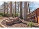 Brick-edged, mulched garden area featuring tiered planters, near the home's deck steps at 3660 Hickory Se Cir, Smyrna, GA 30080