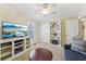 Cozy living room with TV, bookshelves, and a comfortable blue sofa at 3660 Hickory Se Cir, Smyrna, GA 30080