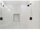 Modern shower featuring white tile, a built-in soap dish and a bronze shower head and faucet at 3660 Hickory Se Cir, Smyrna, GA 30080