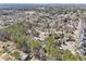 Aerial view of a neighborhood with two-story homes and lush greenery, and Atlanta in the distance at 3812 Chalmers Ct, Clarkston, GA 30021