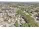 Aerial view of a two-story home surrounded by lush greenery and other homes at 3812 Chalmers Ct, Clarkston, GA 30021