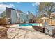 Backyard showcasing the private pool, lounge area, and mature trees at 3812 Chalmers Ct, Clarkston, GA 30021