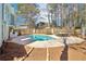 Backyard showcasing the private pool, lounge area, and mature trees at 3812 Chalmers Ct, Clarkston, GA 30021