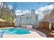 Backyard showcasing the private pool, lounge area, and mature trees at 3812 Chalmers Ct, Clarkston, GA 30021