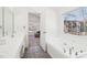 Bathroom features double sinks, a jacuzzi tub, and lots of natural light at 3812 Chalmers Ct, Clarkston, GA 30021