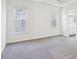 A bedroom with large windows and neutral carpet at 3812 Chalmers Ct, Clarkston, GA 30021