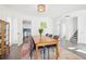 Bright dining room with a wooden table, six chairs, and a stylish light fixture at 3812 Chalmers Ct, Clarkston, GA 30021