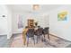 Dining room featuring wood table, six chairs, modern light fixture and colorful rug at 3812 Chalmers Ct, Clarkston, GA 30021