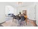 Bright dining area with a wooden table, six chairs, and an open view to the living room at 3812 Chalmers Ct, Clarkston, GA 30021