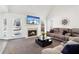 Living room featuring a fireplace, plush seating, and natural light from surrounding windows at 3812 Chalmers Ct, Clarkston, GA 30021