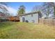 View of the grassy backyard and the back of the house with a wooden deck at 2222 Hill Nw St, Atlanta, GA 30318