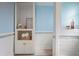 Bright bathroom featuring built-in storage with wood-look tile flooring and blue accent wall at 2222 Hill Nw St, Atlanta, GA 30318