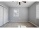 The bedroom features plush carpeting, a ceiling fan, a window, and a double-door closet at 2222 Hill Nw St, Atlanta, GA 30318