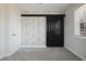 This bedroom features modern wallpaper and a sliding closet door and second entrance at 2222 Hill Nw St, Atlanta, GA 30318