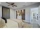 Bedroom boasting brick accent wall, ceiling fan, with doorway leading to modern kitchen, and a decorative rug at 2222 Hill Nw St, Atlanta, GA 30318