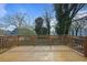 Large wooden deck offering an outdoor living space surrounded by mature trees at 2222 Hill Nw St, Atlanta, GA 30318