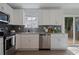 Bright kitchen with stainless steel appliances, granite countertops, and a sliding door to the outside deck at 2222 Hill Nw St, Atlanta, GA 30318