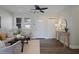 Cozy living room featuring hardwood floors, a ceiling fan, large windows, and stylish decor at 2222 Hill Nw St, Atlanta, GA 30318