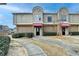 Two-story townhome with red awning and manicured landscaping at 3301 Henderson Mill Rd # R1, Chamblee, GA 30341