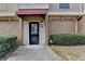 Townhome entrance with black door and red awning at 3301 Henderson Mill Rd # R1, Chamblee, GA 30341