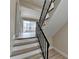 Modern staircase with black metal railing and light wood steps at 3301 Henderson Mill Rd # R1, Chamblee, GA 30341