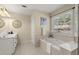 Spa-like bathroom with soaking tub and double vanity at 3669 White Sands Way, Suwanee, GA 30024